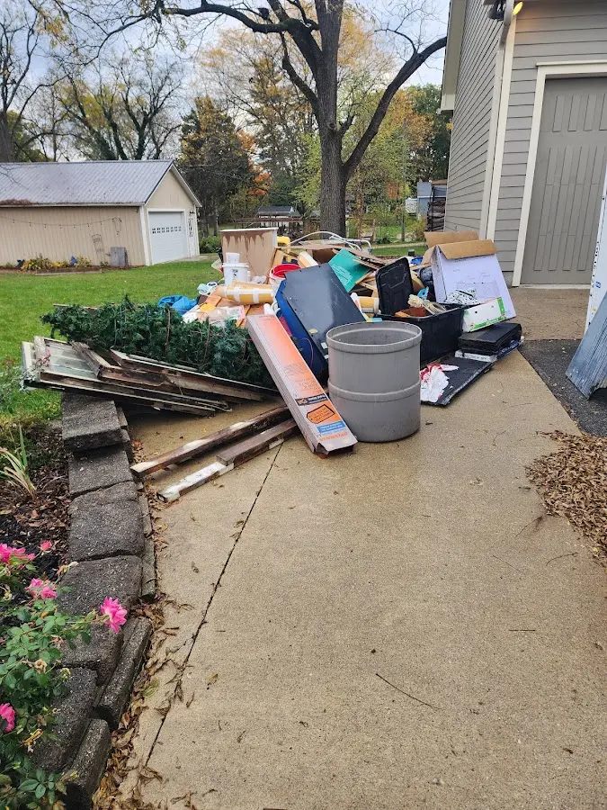 Dumpster being loaded with debris for Roofing Dumpster Rental in Clinton